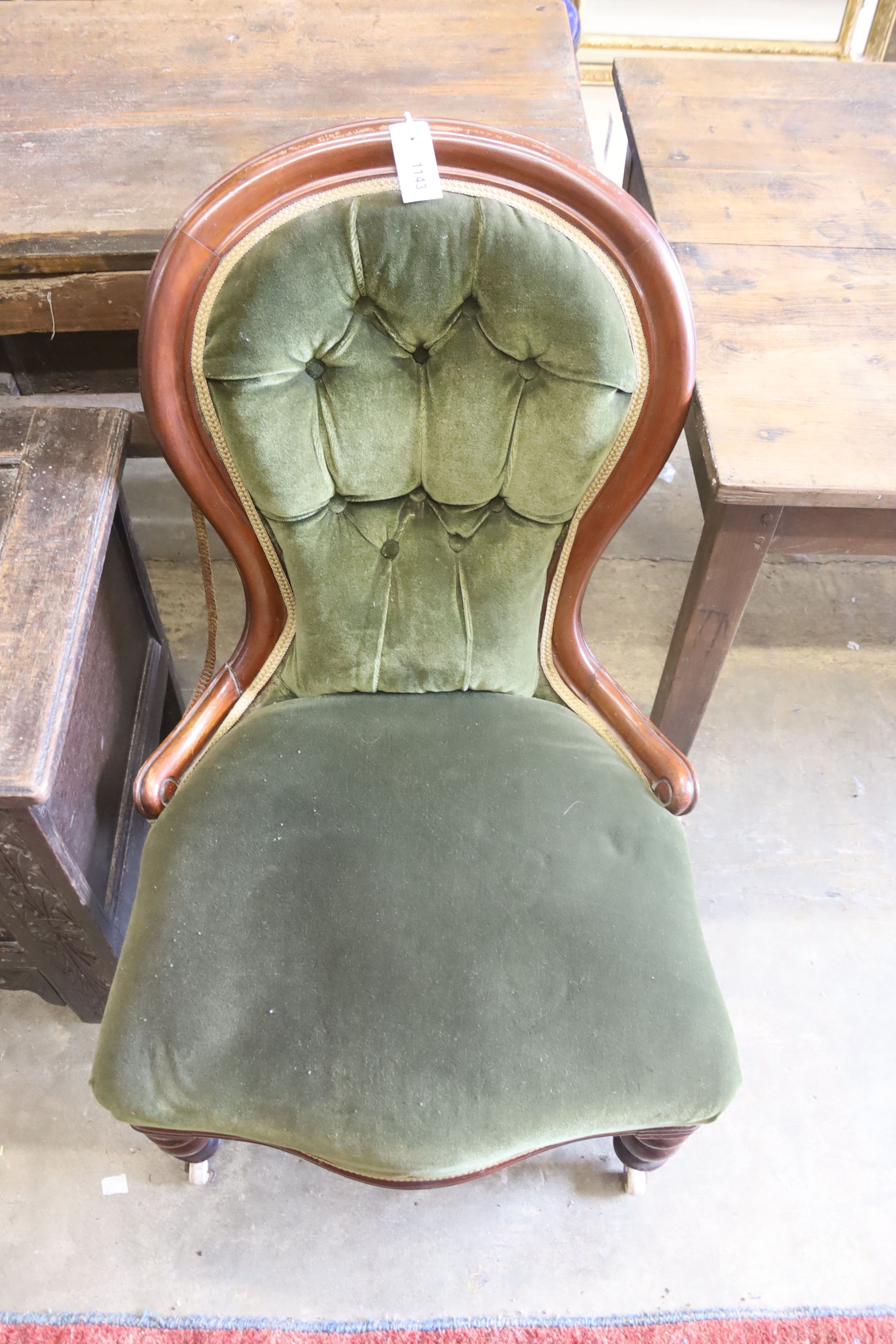 A Victorian mahogany spoon back nursing chair